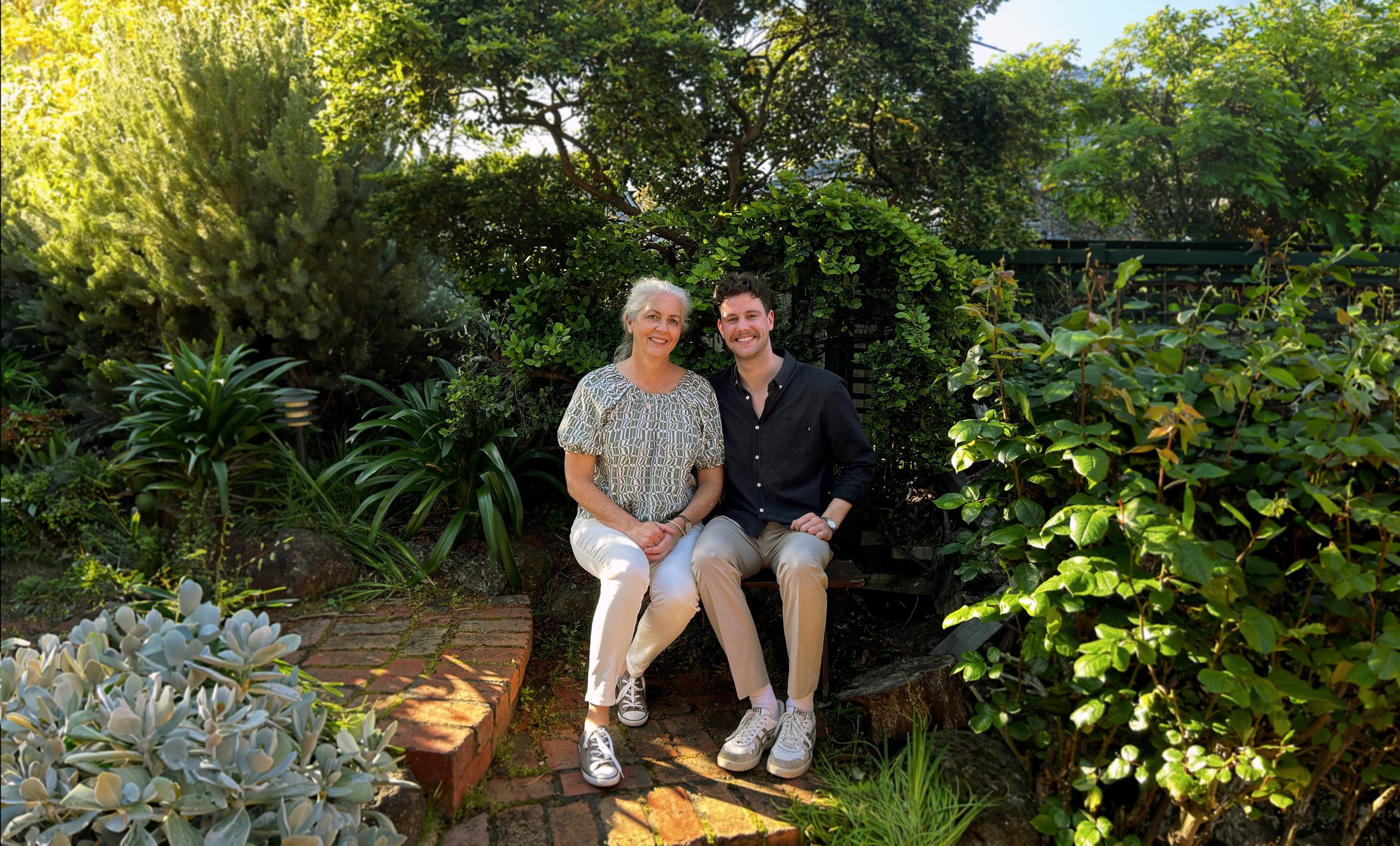 Juanita and Nick Hardy, MidwithMe co-founders, sitting in a Melbourne garden